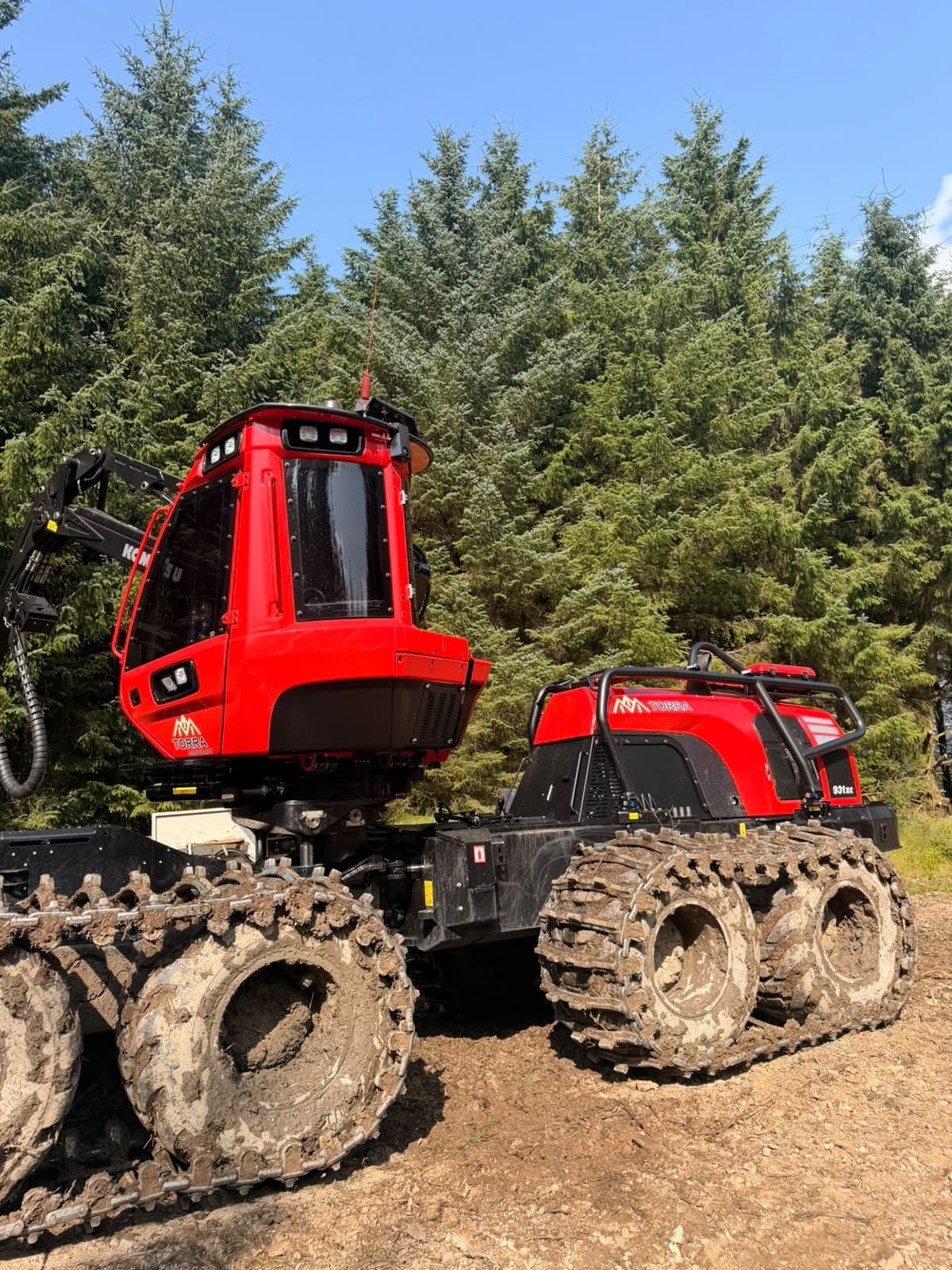 Torra-branded Komatsu 931XC harvester in front of a spruce stand