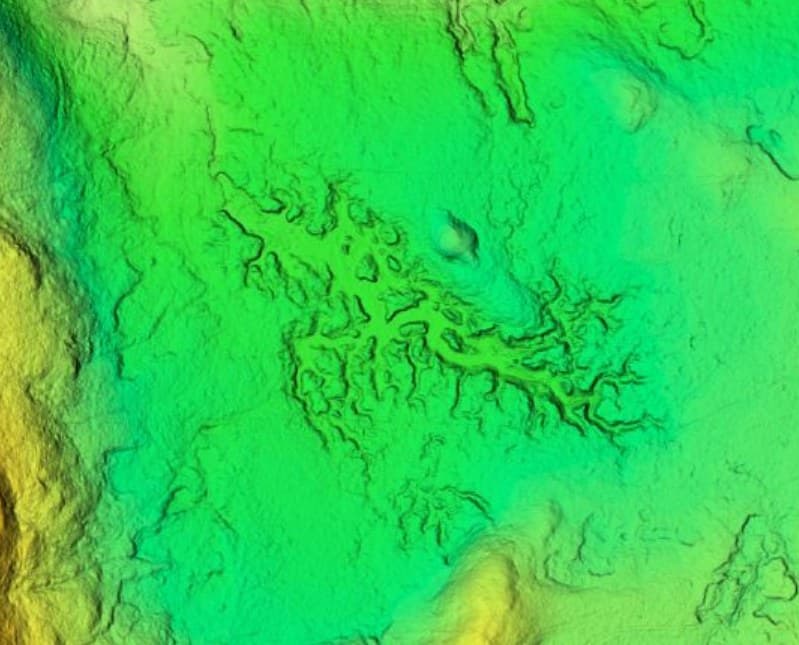 Drone terrain model of upland moor, coloured by height, showing a gully network
